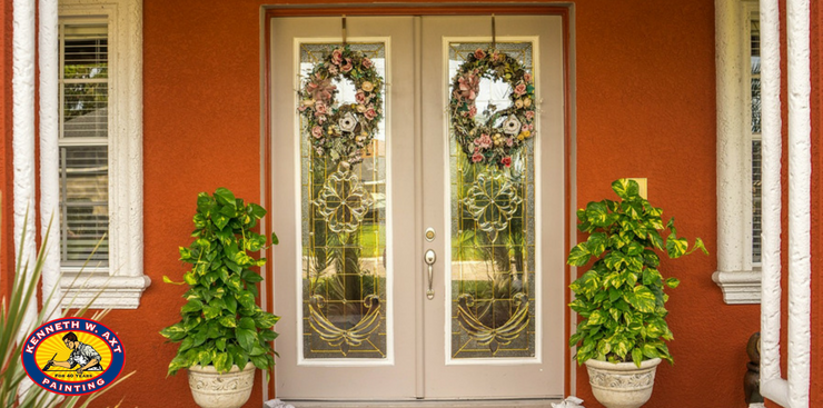 Beautifully decorated porch entrance way with wreaths & planters | Kenneth Axt Painting logo